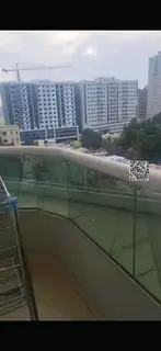 Two bedrooms and a living room with a balcony and parking