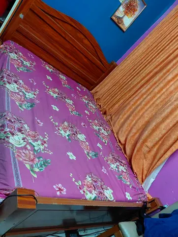 Comfortable Wooden Bed with Floral Design
