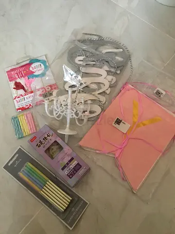 Various party supplies, primarily candles and birthday decorations: Set of 12 Hallmark candles in go