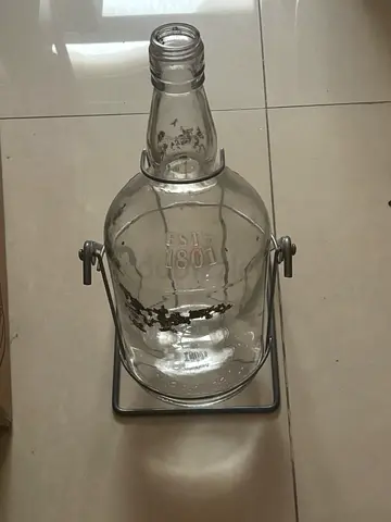 Rare Vintage  possibly half a gallon glass bottle on tilted metal silver gray stand