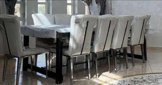Black wooden table including 10 chairs  all for 1600 AED