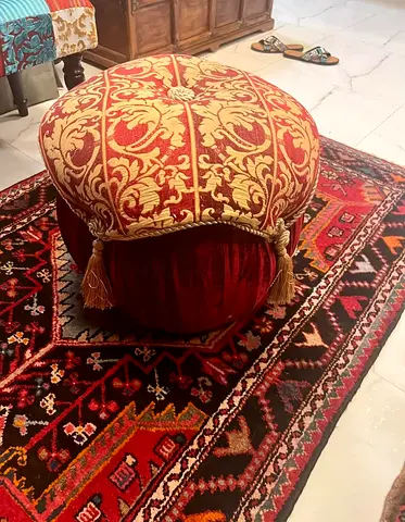 Elegant Red Ottoman with Decorative Tassels
