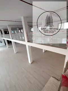 Luxury showroom for rent in Al Jurf Industrial Area 2 – large space with mezzanine, elevator, and 