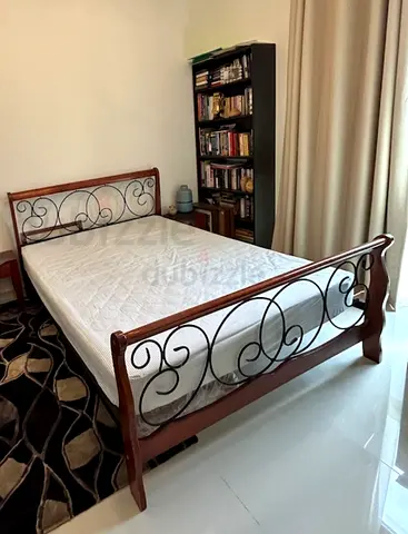 Elegant Wooden Bed with Intricate Ironwork