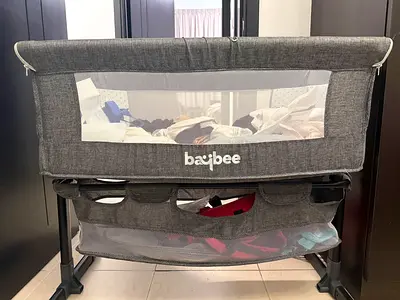 Baby bedside crib adjustable height with bottom storage and mosquito net attachment