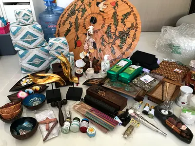 A collection of various souvenirs, home decor items, and incense burners from various countries, par