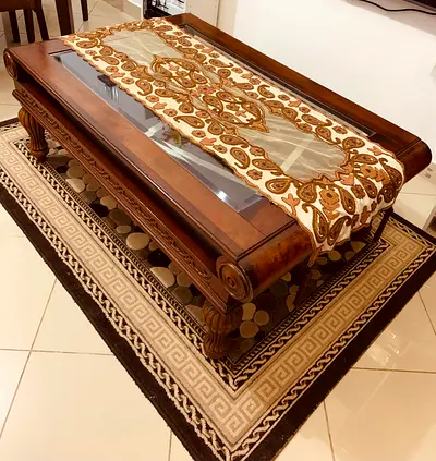 Elegant Glass-Top Coffee Table with Intricate Design