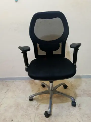 Office chair for sale in black with back support, reclining backrest, and adjustable armrests.