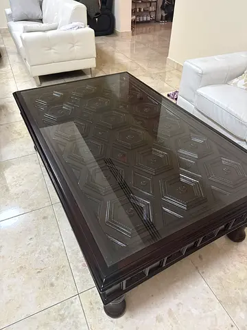 Elegant Glass Top Coffee Table with Intricate Design