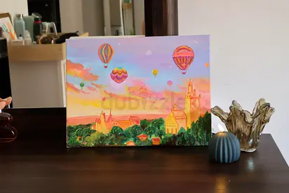 A ready to hang on canvas dreamy hand painting of a beautiful scenary with hot air baloons.