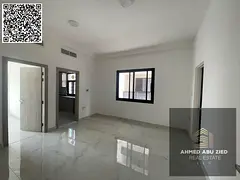 For annual rent in Ajman, a spacious one-bedroom apartment with a living room, two bathrooms, and sp