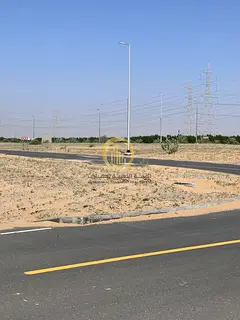Land for sale in Mazir'ah B area, measuring 2850 sq ft, second plot from Emirates Road, close to