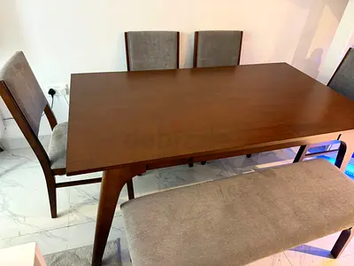 Wooden dining table for 6 people with 4 chairs and a bench, used for six months only.