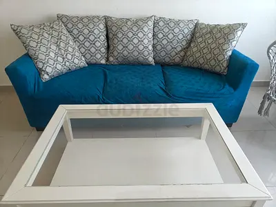 Comfortable sofa with cushions and sofa cover plus center table price only 150 aed