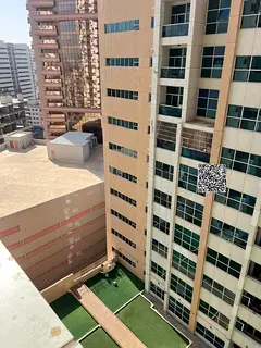 For annual rent in Ajman Towers, one apartment with two bedrooms a living room a balcony and parking