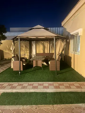 Elegant Outdoor Patio Seating with Center Layout and Built-in Ceiling Lighting