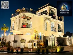 In Al Bahia area, Ajman, a corner villa with two floors and a roof, fully air-conditioned, freehold