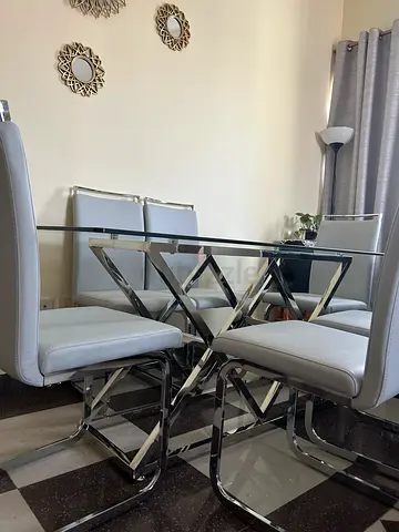 Modern Glass Dining Table with Stylish Chrome Chairs