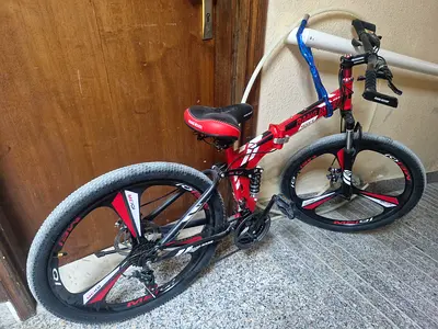 Red and Black Mountain Bike for Sale,excellent condition, bought for 700aed