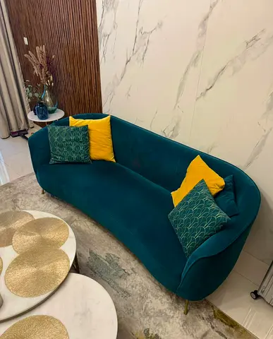 Stylish Curved Sofa in Teal with Yellow Accents