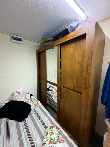 Single bed with closet and dresser mirror