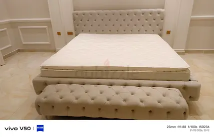 Elegant King Size Bed with Stylish Headboard and Ottoman