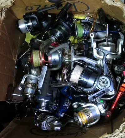 BOX OF MIXED FISHING REELS SPARE PARTS