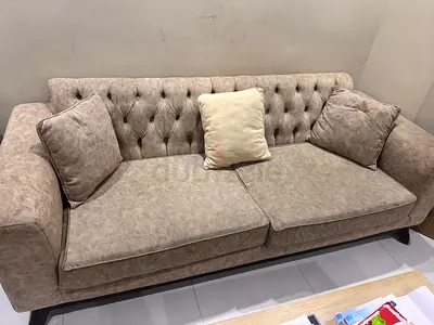 Comfortable Beige Sofa with Tufted Design