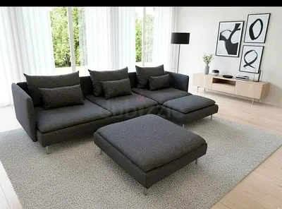 This modern L-shaped sectional sofa features a sleek dark grey fabric finish with deep, comfortabl