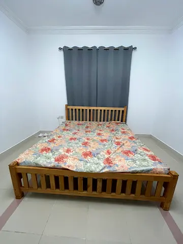 Solid Wooden Bed with Floral Bedding