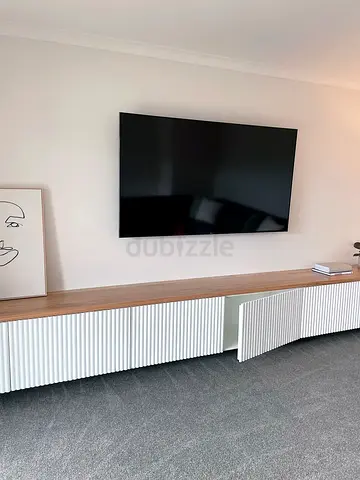 Minimalist TV Wall Unit with Fluted Cabinet and Clean Panel Design