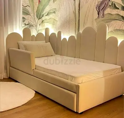 Cozy, cloud‑soft daybed with scalloped luminous headboard and hidden storage drawers for a sleek, s