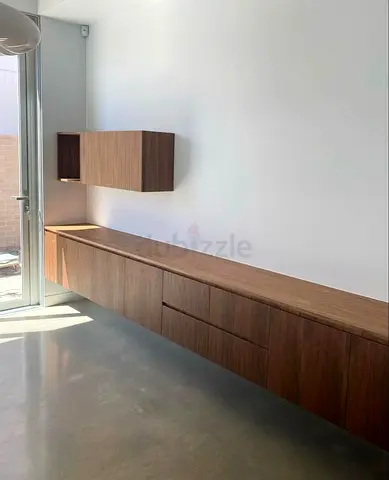 Modern Wall Mounted Media Unit with Rounded Corners and Slatted Design