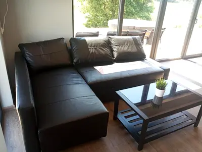 Stylish Black Leather Sectional Sofa with Coffee Table