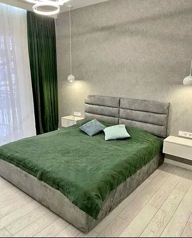 Stylish Grey Upholstered Bed with Green Bedding