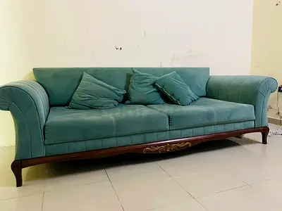 Elegant Turquoise Sofa with Decorative Pillows