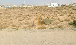 **For Sale: Residential Plot on Two Streets in Al Raqiba, Sharjah**