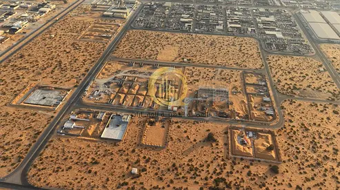 Land for sale in the heart of the scrap market (auto parts), prime area 17,000 sq ft, 24-meter street, ready for construction, Al Sajaa Industrial Are