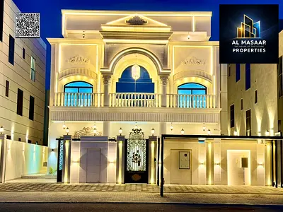 A two-story villa with a rooftop terrace in the most prestigious area of ​​Ajman, featuring an internal elevator, electricity, and water directly on t