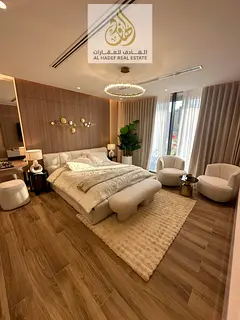Own a fully furnished two-bedroom apartment with a living room in the Tiger Downtown Ajman project w
