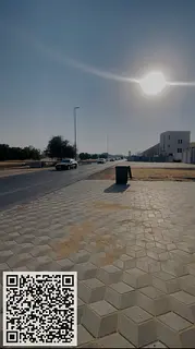 For sale, land in Al-Halio 1, corner of two streets on a main street, including registration fees