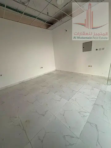 Shop for annual rent in Al Jurf Industrial City, excellent location on a main street