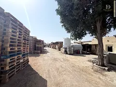 A walled plot of land for rent in Sharjah, Al Sajaa Industrial Area.