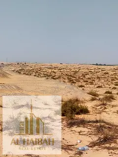 Residential land for sale in Sharjah, prime location and price, corner plot on two streets.