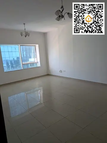 شقة غرفة وصالة للإيجار | إطلالة الممزر | جيم + حراسة 24 ساعة | برج تايجر 2 – التعاون، الشارقة | 42,000 درهم سنوي