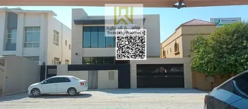 A new luxury villa for sale in Al Rawda 1, Ajman, features a sophisticated, modern design that combi