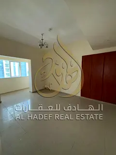 For rent in Al Taawun: Three rooms and a living room, first row on the Corniche, with air conditioni