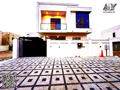 Own a villa ready with electricity and water, very close to Al Hamidiya Park in Al Yasmin, 5 master