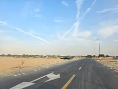Corner plot of land for sale in Sharjah, Al Houshi area, Al Badi' suburb.
