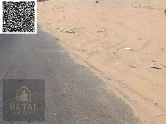 Residential land for sale in Al Yasmin, Ajman, behind the park.